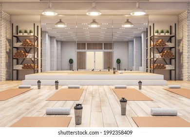 Luxury Concrete Yoga Gym Interior With Equipment, Daylight And Wooden Flooring. Healthy Lifestyle Concept. 3D Rendering