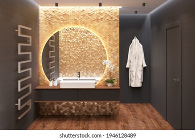 Luxury Dark Bathroom With An Overhead Washbasin On A Wooden Cabinet Near A Large Round Mirror On A Gold Mosaic Wall, A Door, A Heated Towel Rail, A Bathrobe, Black Walls, A Wooden Floor. 3d Render