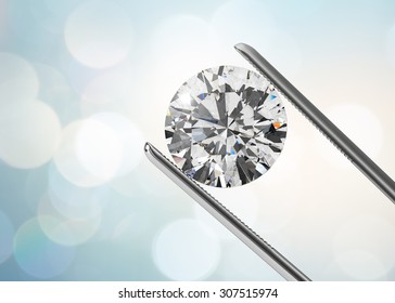 Luxury diamond in tweezers closeup with bright bokeh background