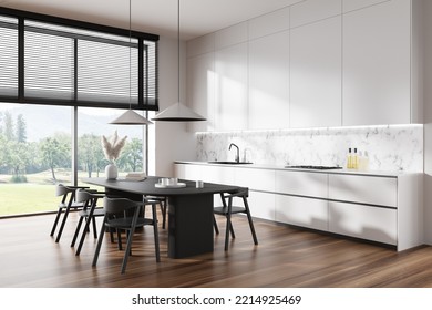 Luxury Kitchen Interior With Chairs And Dining Table, Side View, Hardwood Floor. Meeting Space And Panoramic Window On Countryside View. 3D Rendering