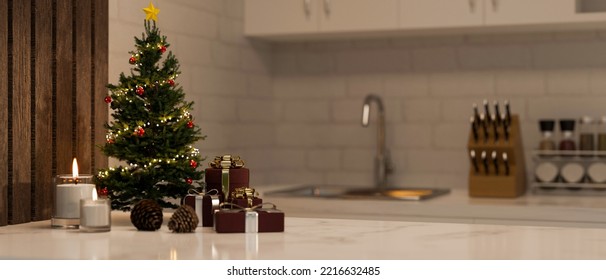 Luxury white marble kitchen tabletop with small Christmas tree, candles, Christmas gifts and copy space over blurred modern white kitchen in the background. 3d render, 3d illustration