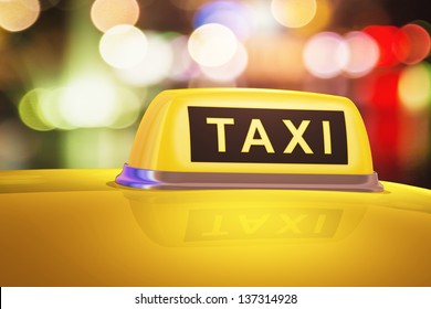 Macro View Of Yellow Taxi Sign On Car In Evening Or Night City Street Outdoors