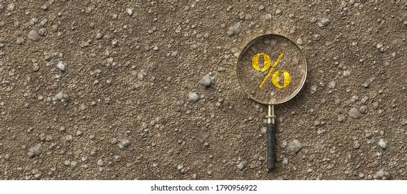 magnifying glass with percent sign on dirt gravel background - 3d illustration