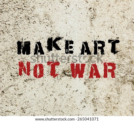 Make Art Not War message graffiti painted on a concrete wall