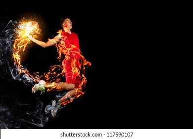 Male Basketball Player Jumping And Practicing With A Ball