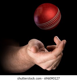 A Male Hand Tossing A Cricket Ball Up In The Air On An Isolated Dark Background - 3D Render