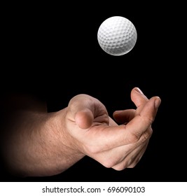 A Male Hand Tossing A Golf Ball Up In The Air On An Isolated Dark Background - 3D Render