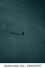 Man In Black Suit Runs In Desert At Twilight. Aerial View. 3D Render.