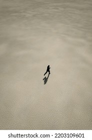 Man In Black Suit Runs In Desert. Aerial View. 3D Render.