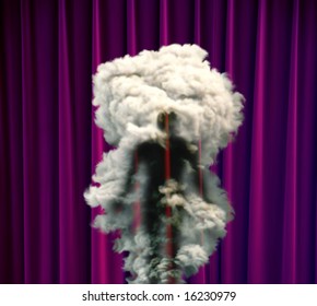 A Man Disappears In A Puff Of Smoke On Stage Against A Purple Curtain