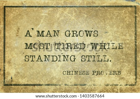 A man grows most tired while standing still - ancient Chinese proverb printed on grunge vintage cardboard