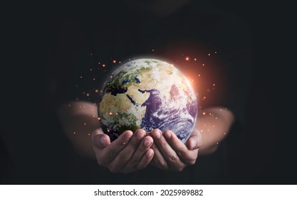 Man holding planet by two hands for earth day and saving energy environment concept ,Element of this image from NASA and 3d render.