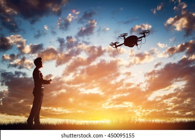 Man operating a drone at sunset using a controller. 3D rendering