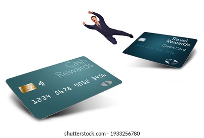 A Man In A Suit Makes The Big Leap From One Type Of Rewards Credit Card To Another In This 3-D Illustration. He Leaps Away From A Travel Rewards Card Hoping To Reach A New Cash Back Rewards Card.
