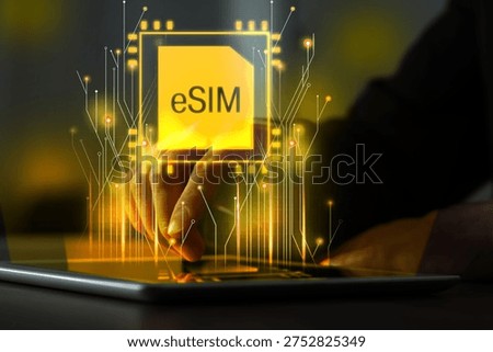 Man using tablet computer at table, closeup. Virtual electronic SIM card (eSIM) above device