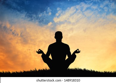 Man In Yoga Pose At Sunset