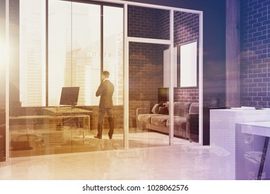 Manager s office interior with white brick walls, panoramic windows, a concrete floor and a gray table. A sofa and posters. A businessman 3d rendering mock up toned image double exposure