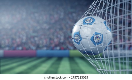 Manchester City F.C. football club logo on the ball in football net. Editorial conceptual 3D rendering