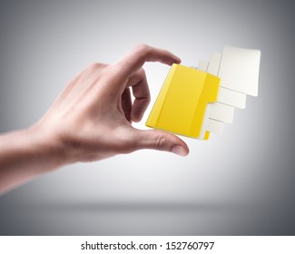 Man's hand holding Yellow folder with a symbol - Shutterstock ID 152760797