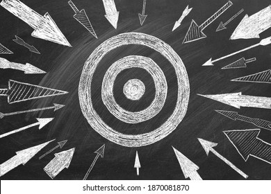 Many different arrows and target drawn in chalk on a blackboard. Concept of competition, strategy, accuracy.