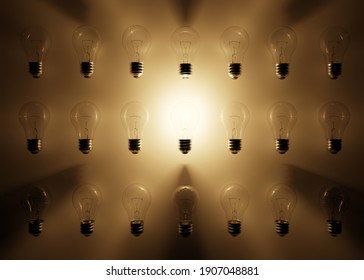 Many Ordinary Bulbs Lie In A Row And Only One Is Lit. The Concept Of Fresh Idea, Creativity And Unconventional Approach