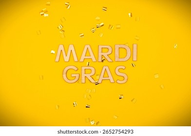 mardi gras write between goldne confetti - mardi gras celebration - february carnival