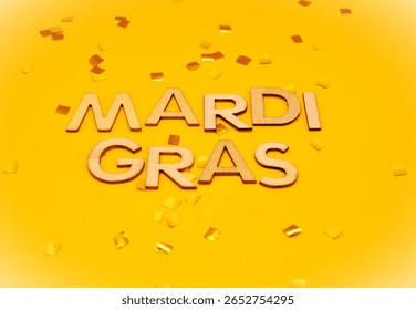 mardi gras write between goldne confetti - mardi gras celebration - february carnival
