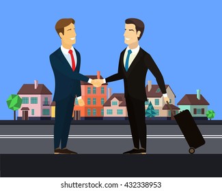 Meeting after a business trip. Businessman meets another businessman with a suitcase on wheels. Asian and European shake hands. Meeting of two businessmen on the street with beautiful colorful houses. - Powered by Shutterstock