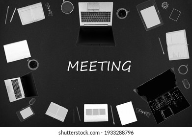 Meeting concept. Top layout of drawings of laptops, notepads, coffee, different business stuff on black background.