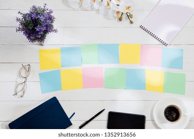 Message at colorful note papers on a desk background. Lifestyle, business, office, plan, goal and management concept. Top or flat lay view. Conceptual image with copy or negative space and mock-up