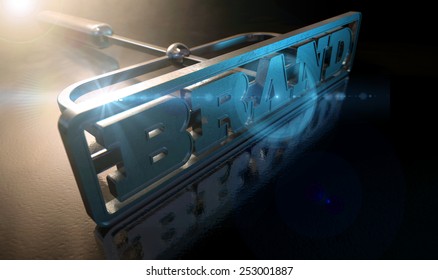 A Metal Cattle Brand With The Word Brand As The Marking Area On An Isolated Dark Backlit Surface And Background