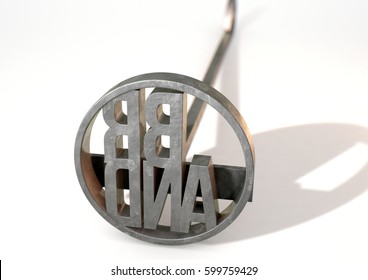 A Metal Cattle Branding Iron With The Word Brand As The Marking Area On An Isolated White Surface - 3D Render