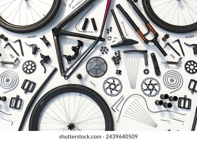 A meticulously arranged display of disassembled bicycle parts spread across a white background, showcasing the detailed complexity involved in bike maintenance and assembly. - Powered by Shutterstock