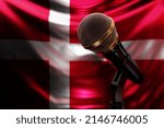 Microphone on the background of the National Flag of Denmark, realistic 3d illustration. music award, karaoke, radio and recording studio sound equipment