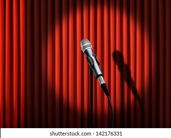 Microphone Under Spotlight Over Red Curtains