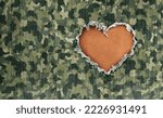 Military Hero love as wartime camouflage fabric with a heart shape hole representing respect for warrior heroes defending freedom and care for wounded soldiers in a 3D illustration style