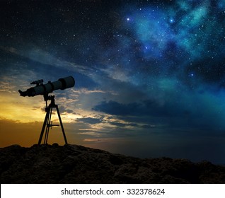 milky way at dawn and silhouette of a telescope