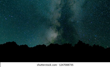 Milky Way Time Lapse Beautiful night sky. Time Lapse - Beautiful Milky Way Galaxy above Mountain Range. Night sky and stars, timelapse milky way and glow above tree forest, star and airliner trails.