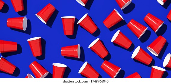 Minimal Creative Composition For Beverage And Party Concept. Red Plastic Solo Drinking Cup On Blue Background. 3d Rendering Illustration. Object Isolate Clipping Path Included.