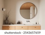 Minimalist bathroom with round mirror, wooden vanity, and sleek fixtures. Warm lighting, neutral tones. Modern interior design. 3D Rendering