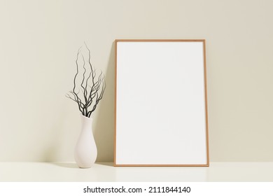 Minimalist and clean vertical wooden poster or photo frame mockup on the floor leaning against the room wall with vase