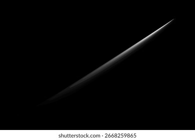 Minimalist close-up image of a sharp blade against a black background.