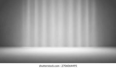 A minimalist gray studio background featuring soft, diffused light rays creating a serene and professional atmosphere. Ideal for product photography or portraiture.