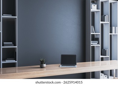 Minimalist modern office with wooden desk, laptop, potted plant, and built-in shelves, on dark wall background. Light and space concept. 3D Rendering