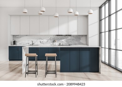 Minimalist White And Blue Kitchen Interior With Breakfast Bar, Two Beige Stools, Pendant Lights, Marble Splashback, Floor To Ceiling Window And Parquet Flooring. Concept Of Modern Design. 3d Rendering