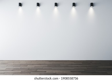 Minimalistic Gallery Interior With Ceiling Lamps And Blank White Wall. Gallery And Art Concept. Mock Up, 3D Rendering