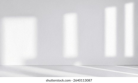 Minimalistic simple light pearl background for product presentation. Streaming sunlight and shadow from the window on perl white gray wall