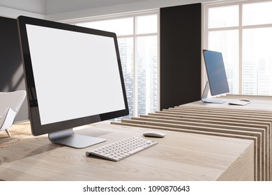 Mock up computer screen standing on a stylish wooden table in a modern company office with large windows and a cityscape. 3d rendering