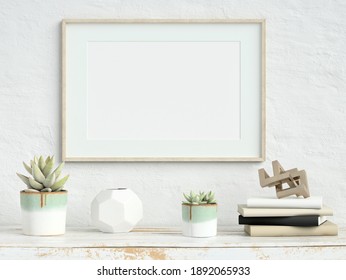 Mock Up Poster Frame On White Plaster Wall With Echeveria Plants In Pots, Books And Geometric Objects On Old Wooden Table; Landscape Orientation; Stylish Frame Mock Up; 3D Rendering, 3D Illustration	