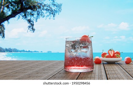 Mocktail Strawberry Soda Not Mix Alcohol. Fresh Strawberries In Ceramic Bowl In The Background Blur On Plank Wood Table. Restaurant At Beach And Sea. Cool Juice Drinks With Ice Cubes. 3D Rendering. 